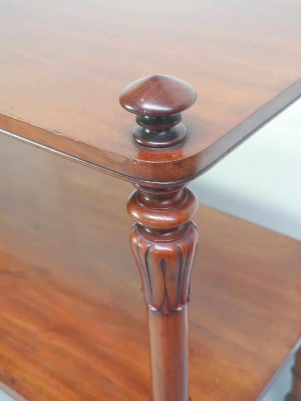 A 19th-century mahogany two-tier buffet table featuring turned support columns, corner finials, and brass castors. View III