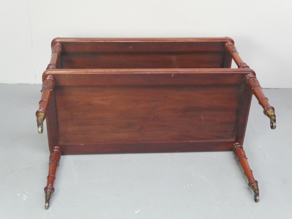 A 19th-century mahogany two-tier buffet table featuring turned support columns, corner finials, and brass castors. View VIII