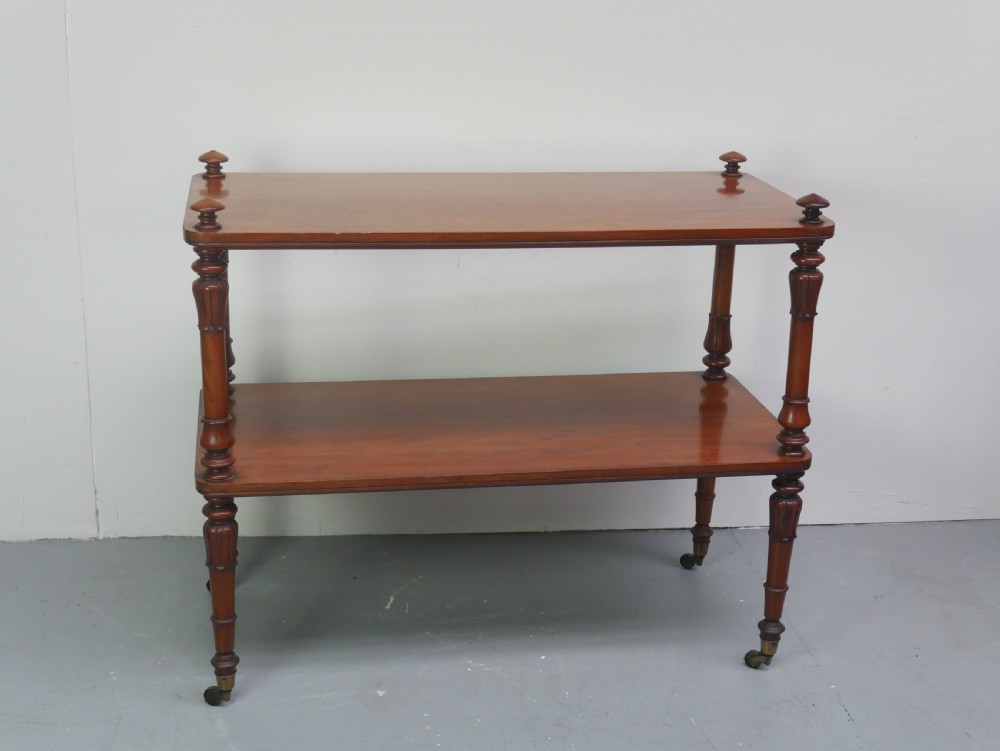 A 19th-century mahogany two-tier buffet table featuring turned support columns, corner finials, and brass castors. View IX