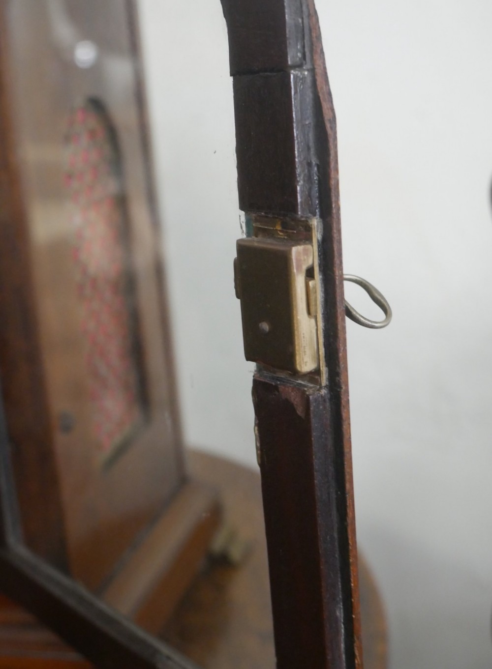 A Georgian mahogany bracket clock featuring an arched top with a brass handle, white dial with Roman numerals, and strike silent sub-dial. View V