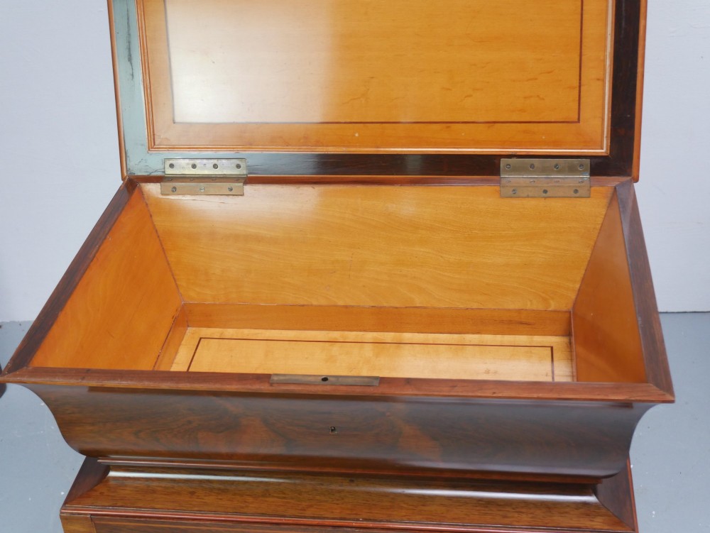 An antique French rosewood box with inlaid monogram resting on a matching stand with curved legs and brass castors. View IV