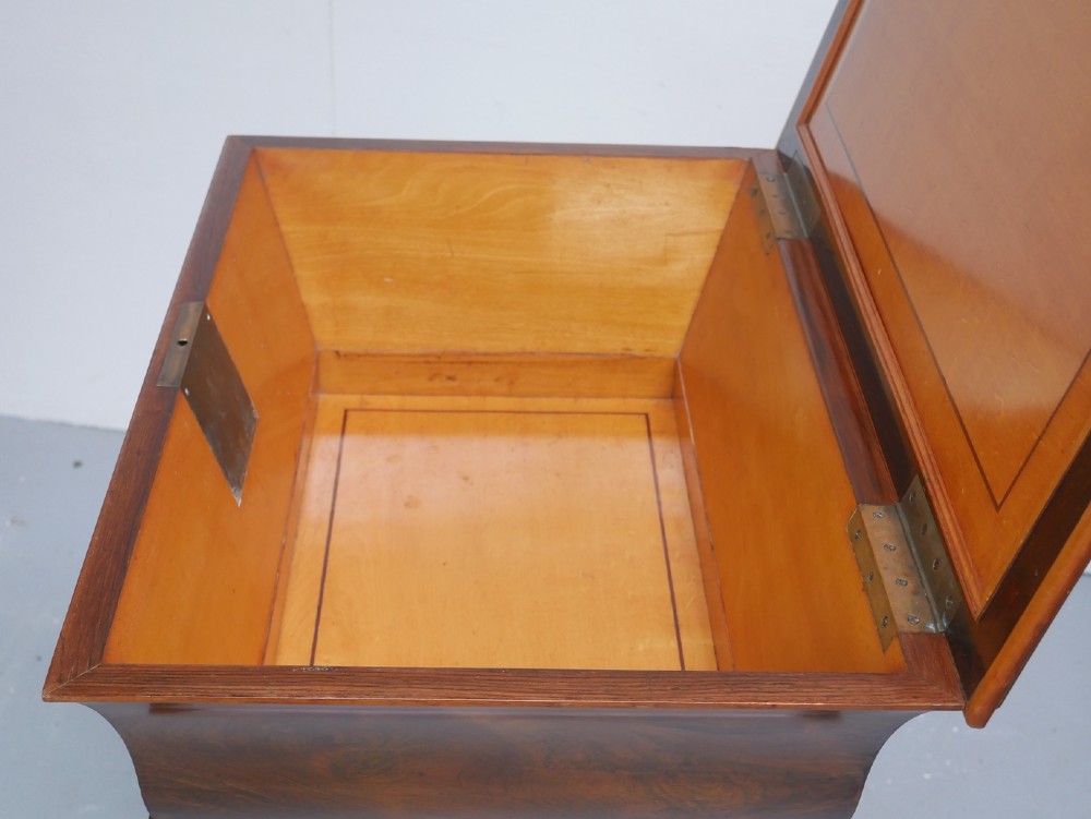 An antique French rosewood box with inlaid monogram resting on a matching stand with curved legs and brass castors. View V