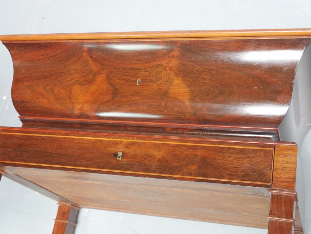 An antique French rosewood box with inlaid monogram resting on a matching stand with curved legs and brass castors. View VII