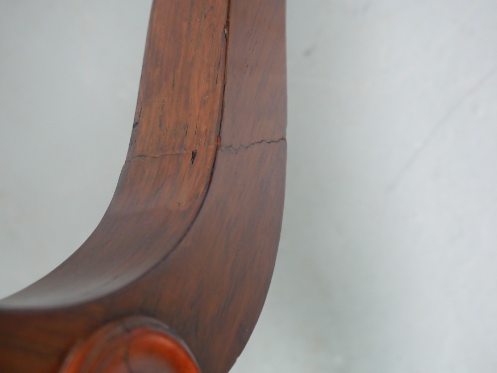 An antique French rosewood box with inlaid monogram resting on a matching stand with curved legs and brass castors. View VIII