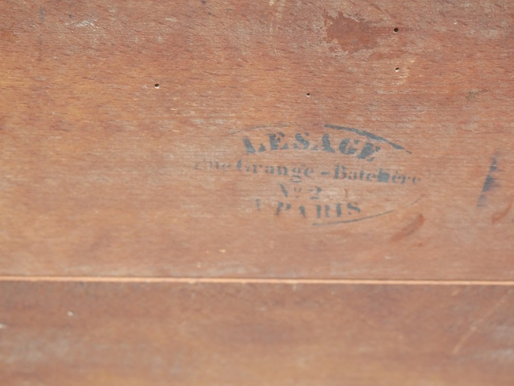 An antique French rosewood box with inlaid monogram resting on a matching stand with curved legs and brass castors. View XI