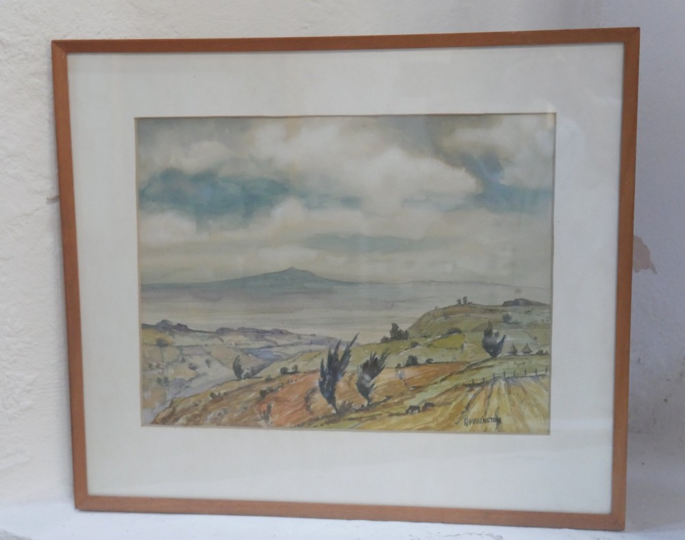 A framed mid-century watercolour landscape depicting Mount Longonot in Kenya with rolling ochre fields beneath a cloudy sky. View VIII