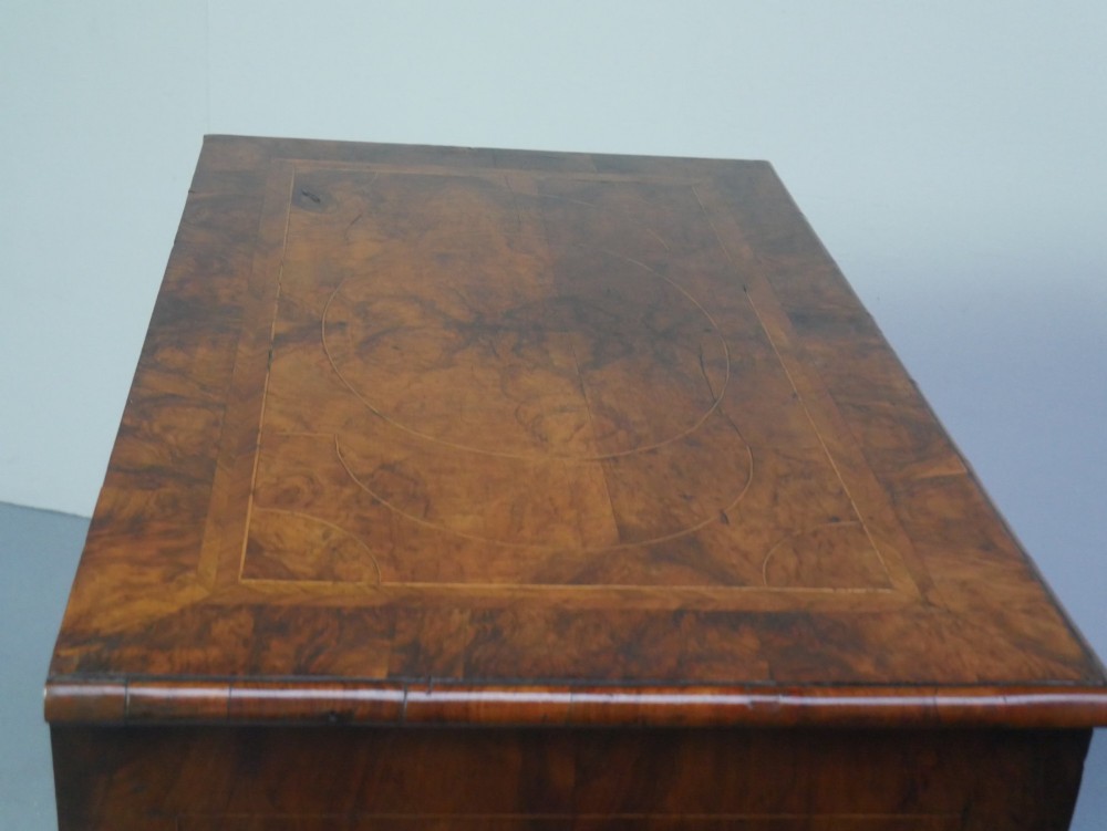 A late 17th-century William and Mary walnut chest on stand featuring multiple drawers with feather inlay, barley twist legs, and bun feet. View VIII