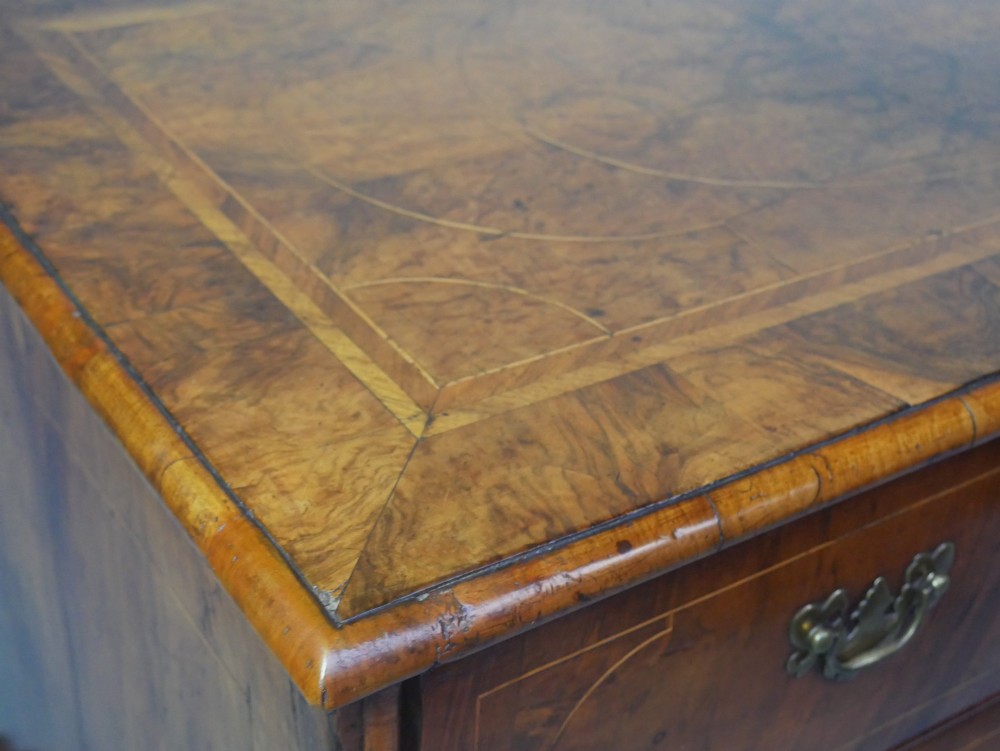 A late 17th-century William and Mary walnut chest on stand featuring multiple drawers with feather inlay, barley twist legs, and bun feet. View IX