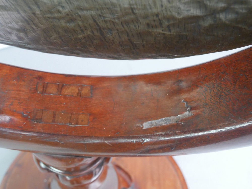 A carved mahogany standing dinner gong featuring a circular frame with a suspended beaten brass gong disc on a turned pedestal. View III