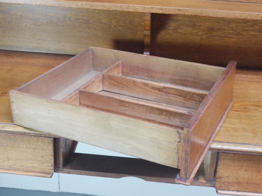 A large Victorian oak serving table featuring a raised back gallery shelf, frieze drawers, and turned front legs. View III
