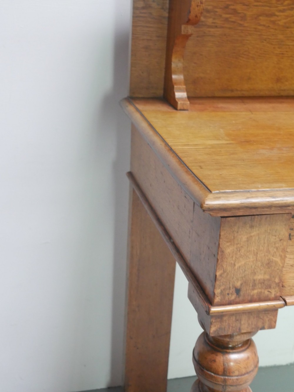 A large Victorian oak serving table featuring a raised back gallery shelf, frieze drawers, and turned front legs. View VII