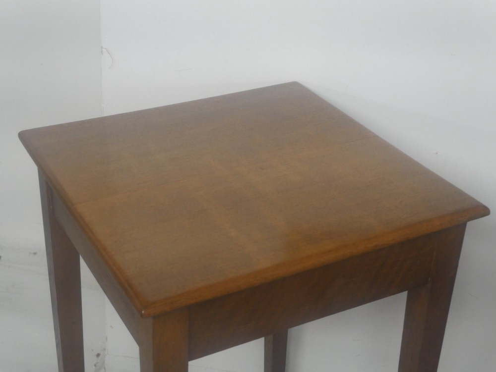A pair of matching square wooden lamp tables made from warm brown oak, featuring square tops and simple tapered legs. View III