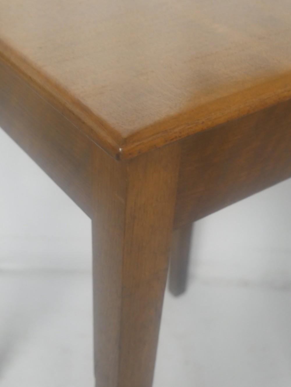 A pair of matching square wooden lamp tables made from warm brown oak, featuring square tops and simple tapered legs. View V