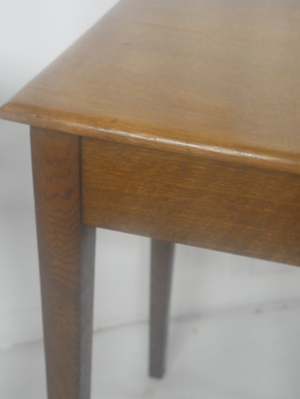 A pair of matching square wooden lamp tables made from warm brown oak, featuring square tops and simple tapered legs. View VI