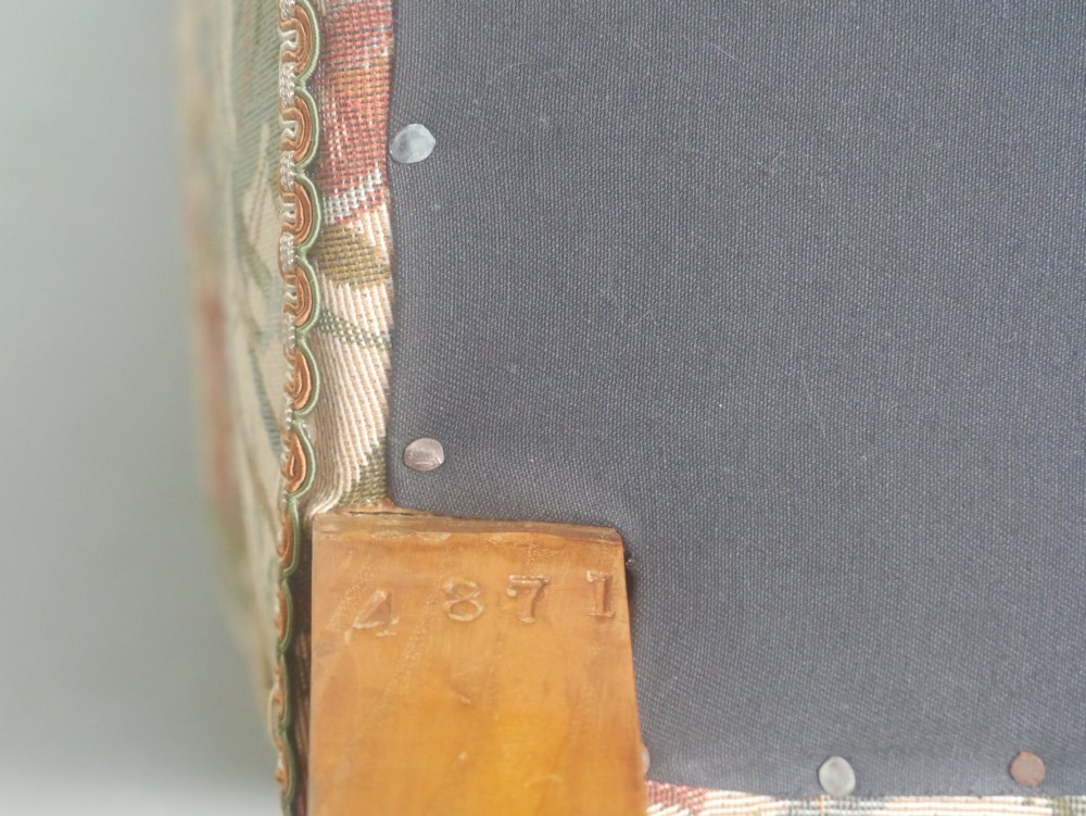 A 19th-century Howard style armchair with button-tufted floral tapestry upholstery, low padded arms, turned timber legs, and ceramic castors. View IX