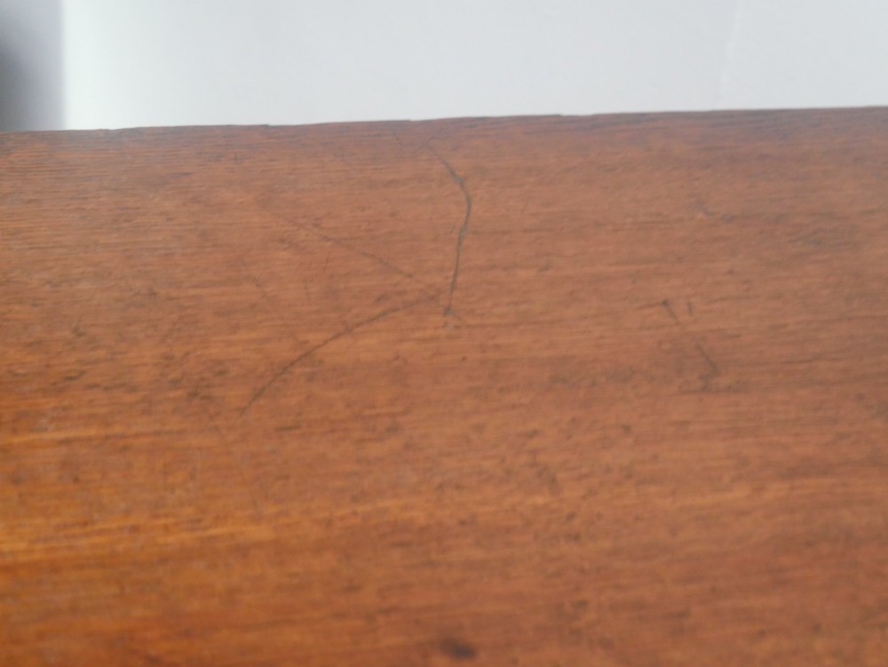 A Georgian oak chest of drawers featuring two short drawers over three long graduated drawers with brass swan-neck handles and bracket feet. View III