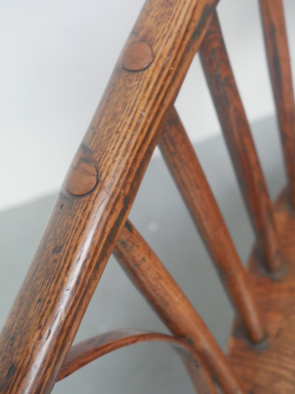A Georgian comb back Windsor armchair featuring vertical wooden spindles, a pierced central splat, curved armrests, and turned legs. View VIII