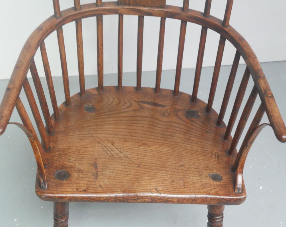A Georgian comb back Windsor armchair featuring vertical wooden spindles, a pierced central splat, curved armrests, and turned legs. View XIII