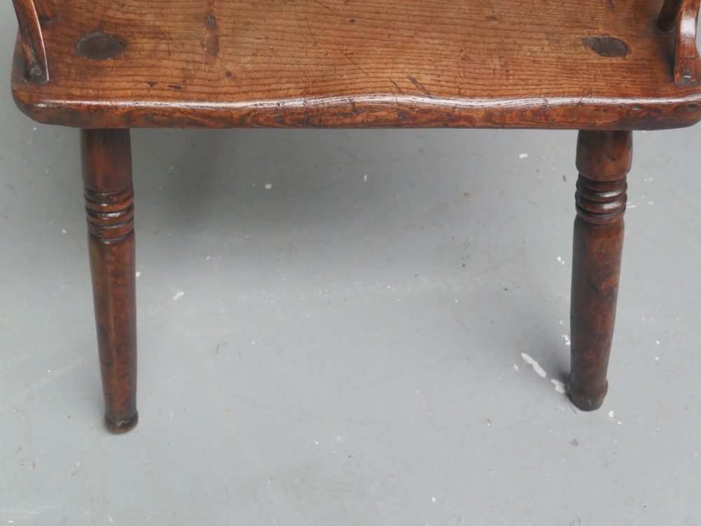 A Georgian comb back Windsor armchair featuring vertical wooden spindles, a pierced central splat, curved armrests, and turned legs. View XIV