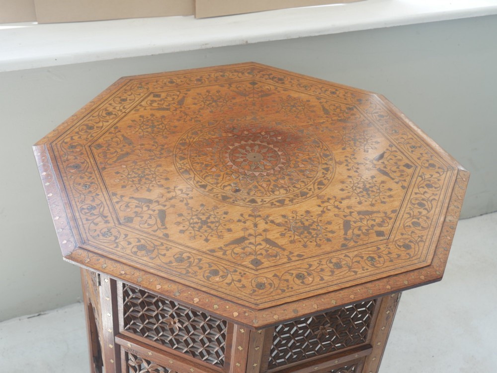 An octagonal Anglo-Indian dark wood side table decorated with intricate bone inlay patterns and pierced jali lattice arches. View II