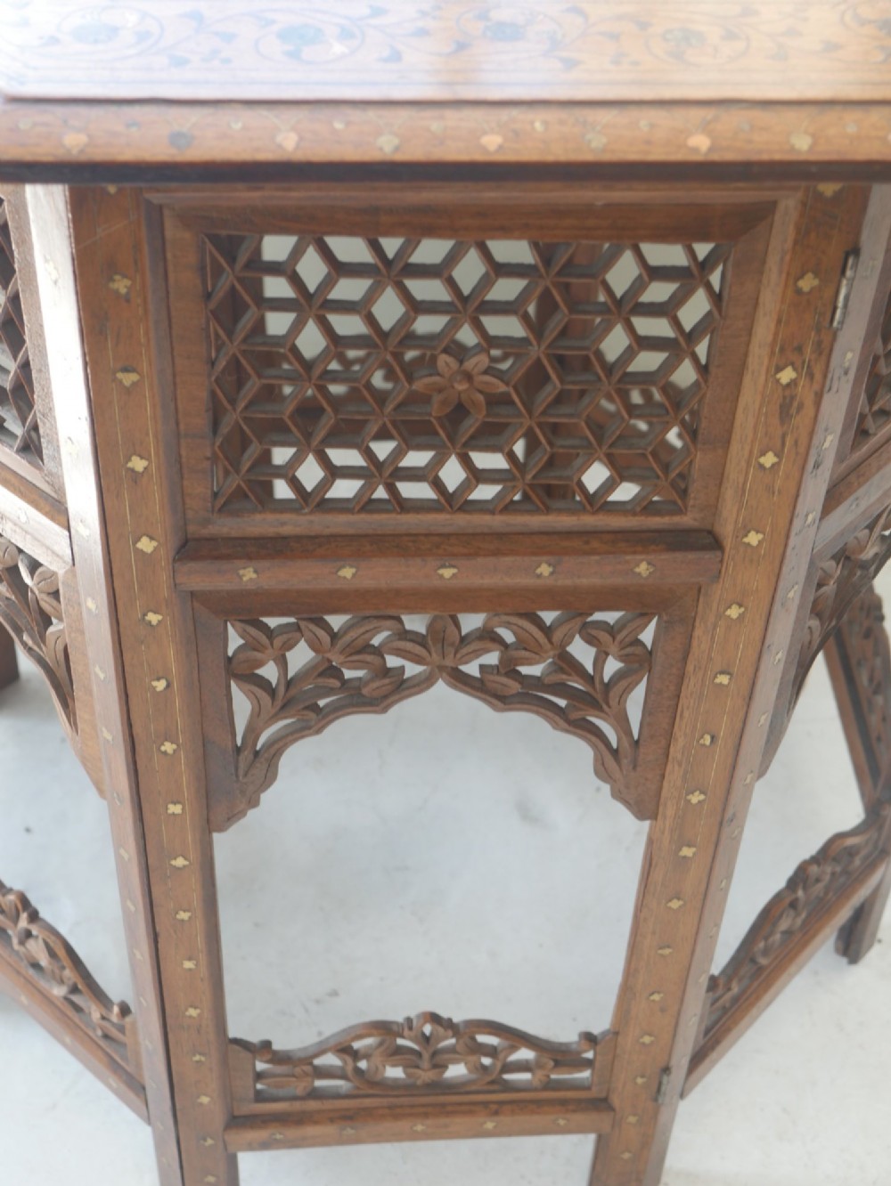 An octagonal Anglo-Indian dark wood side table decorated with intricate bone inlay patterns and pierced jali lattice arches. View VIII