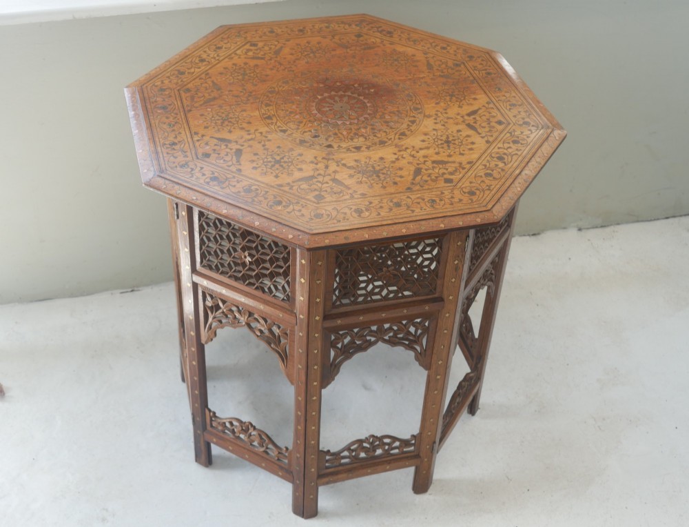 An octagonal Anglo-Indian dark wood side table decorated with intricate bone inlay patterns and pierced jali lattice arches. View X