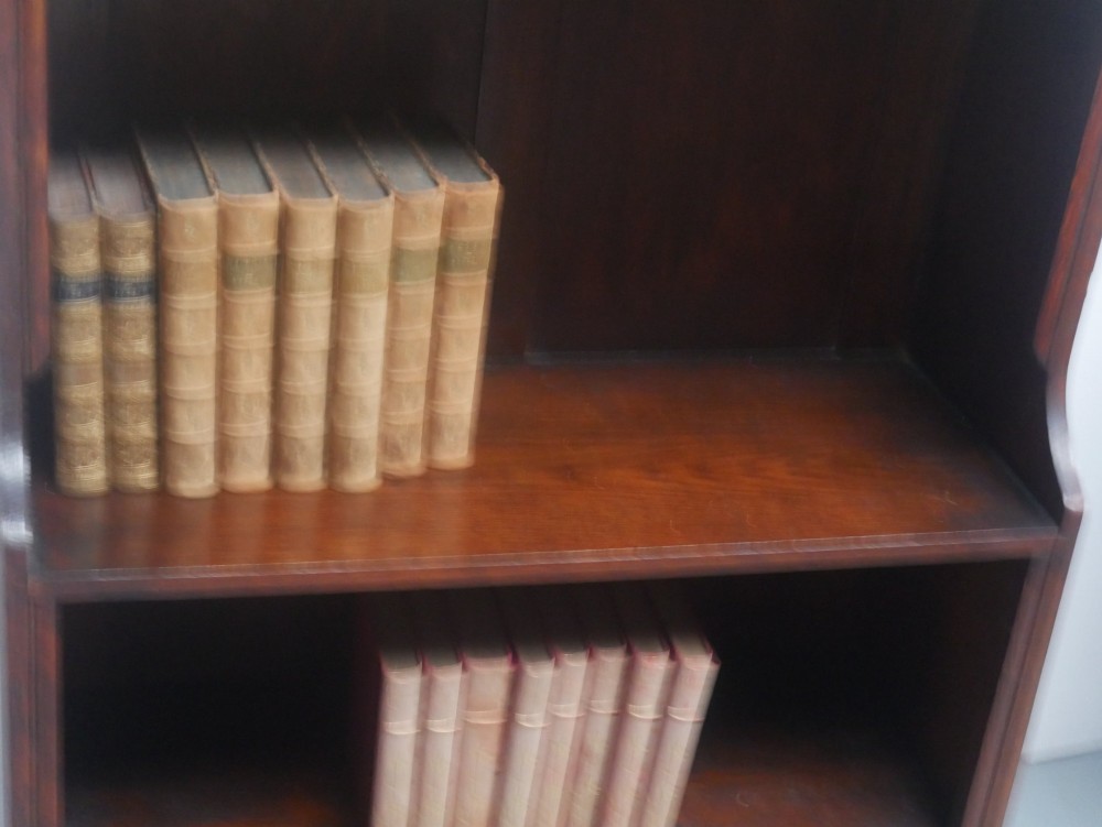 A tall, narrow 1920s dark oak open bookcase featuring five shelves and turned bun feet. View III