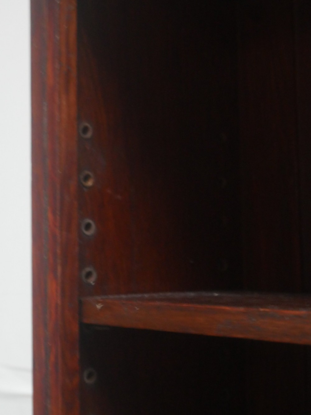 A tall, narrow 1920s dark oak open bookcase featuring five shelves and turned bun feet. View IV