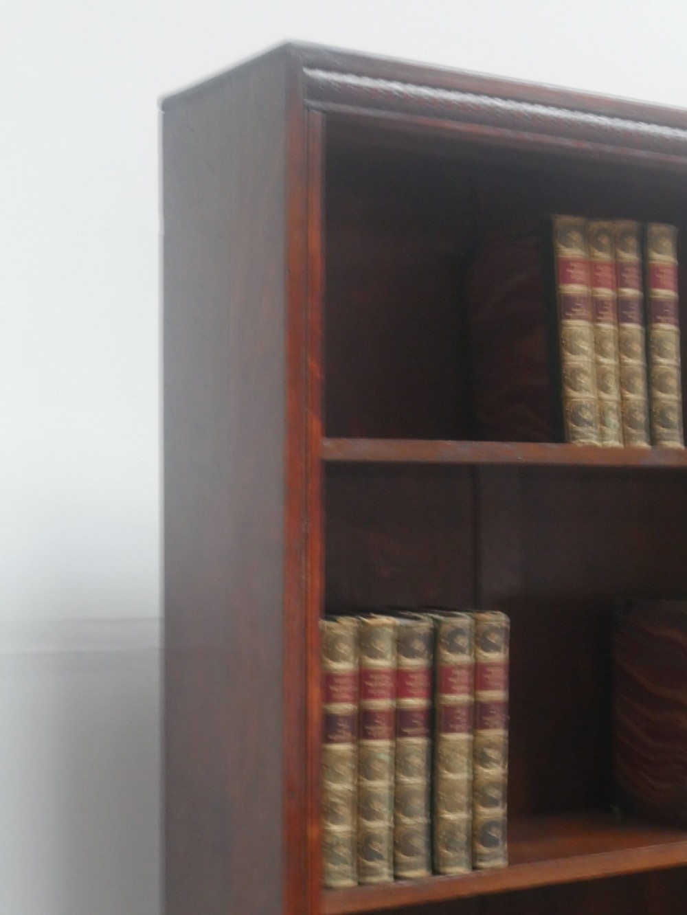 A tall, narrow 1920s dark oak open bookcase featuring five shelves and turned bun feet. View VIII