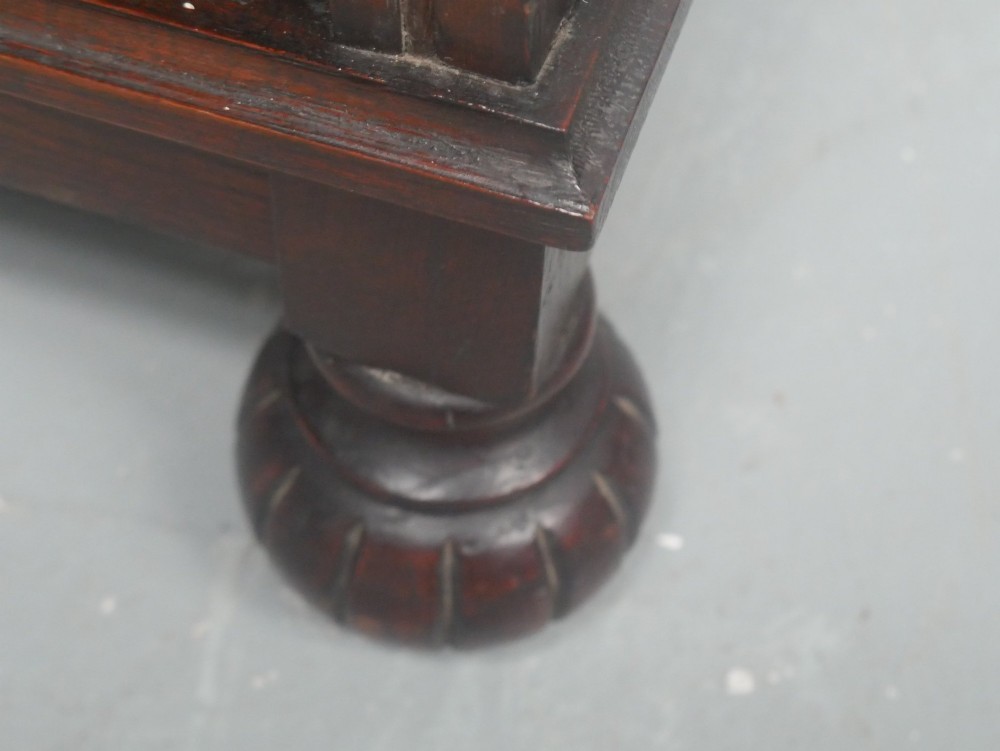 A tall, narrow 1920s dark oak open bookcase featuring five shelves and turned bun feet. View XI