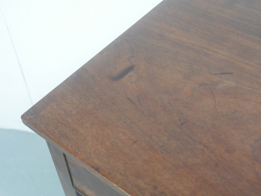 A rectangular Georgian mahogany side table with two frieze drawers, circular brass knobs, and four straight tapered legs. View IV