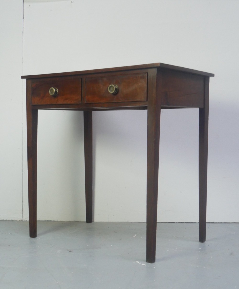 A rectangular Georgian mahogany side table with two frieze drawers, circular brass knobs, and four straight tapered legs. View XI