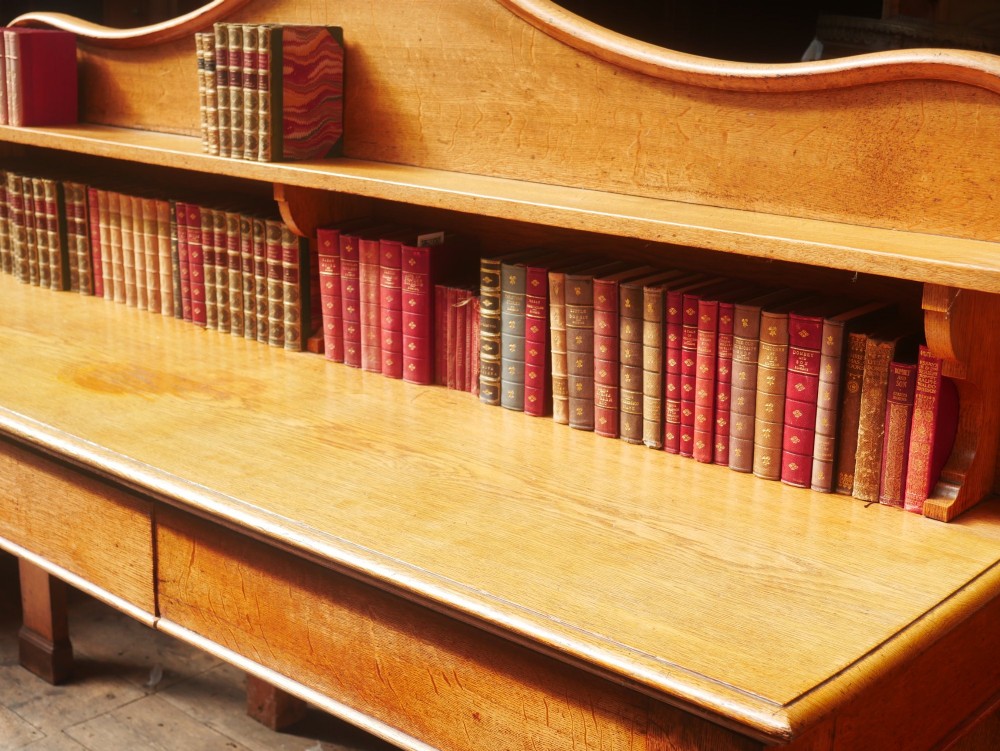 A large Victorian oak serving table featuring a raised back gallery shelf, frieze drawers, and turned front legs. View XII