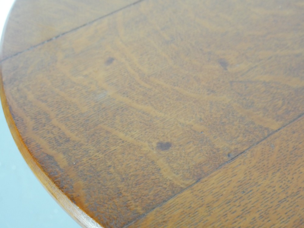 A round 1920s oak lamp table featuring turned legs supported by an X-frame stretcher. View IV