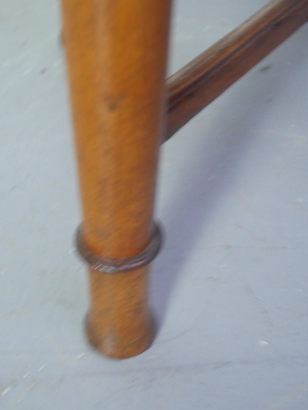 A round 1920s oak lamp table featuring turned legs supported by an X-frame stretcher. View VII