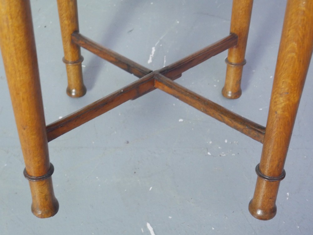 A round 1920s oak lamp table featuring turned legs supported by an X-frame stretcher. View IX