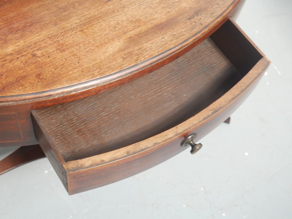 A Georgian mahogany corner washstand featuring a high curved splashback, circular cutouts with a fitted ceramic basin, a middle drawer tier, and splayed legs. View III