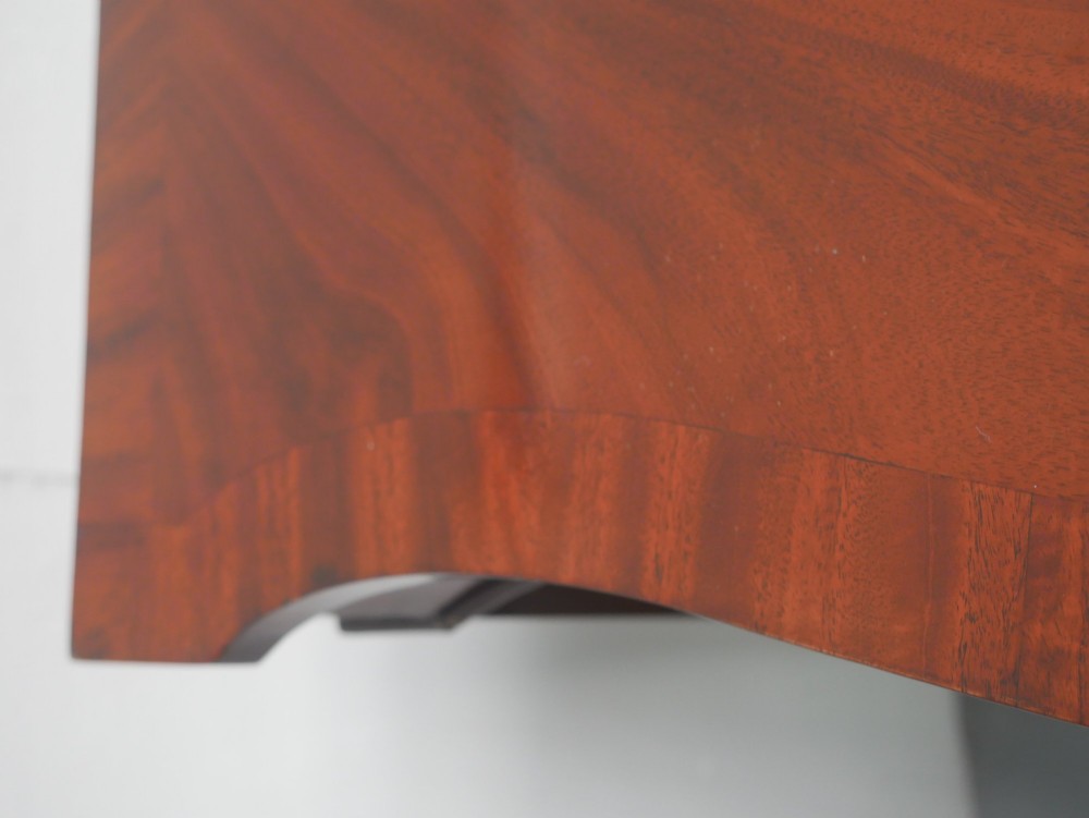 A mahogany console table featuring a shaped top, a lower tier shelf, and tapered square legs. View VIII