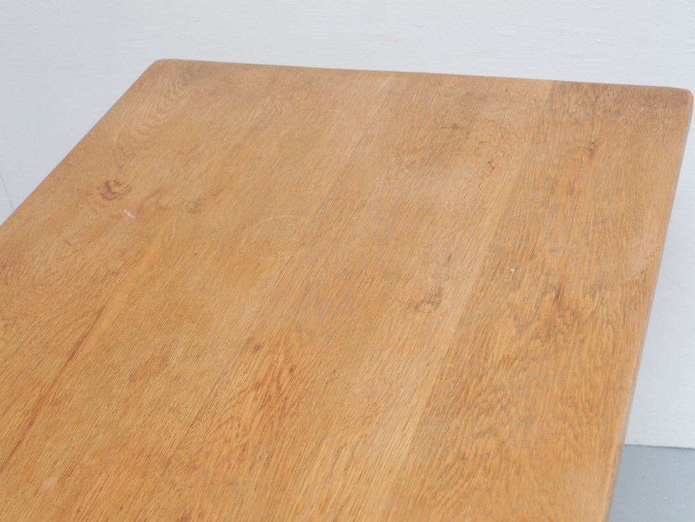 A solid warm brown oak refectory dining table featuring a rectangular plank top, flat trestle leg supports, and a low central stretcher. View VIII