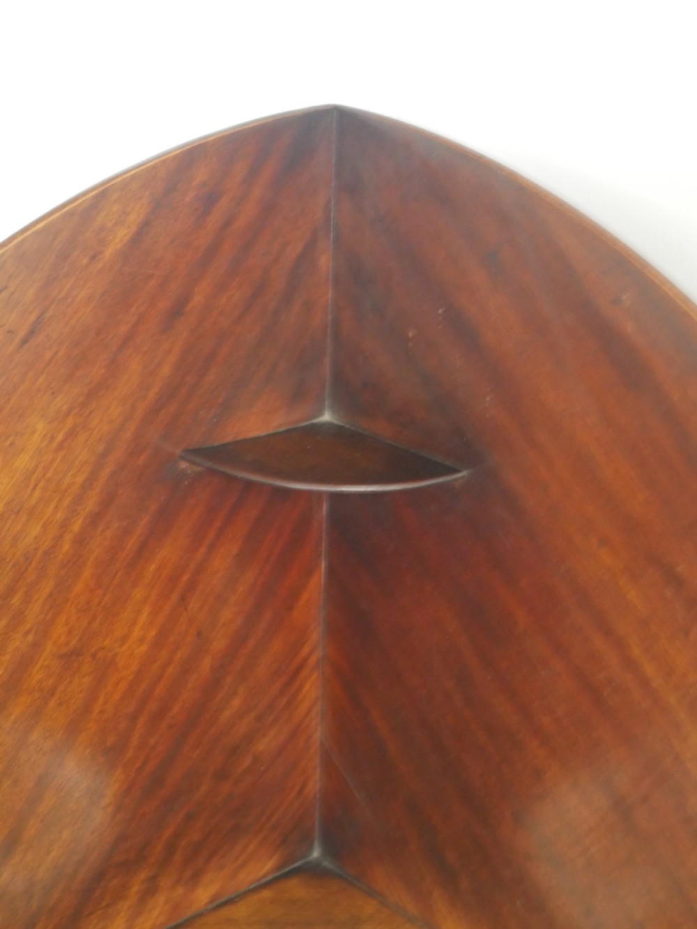 A Georgian mahogany corner washstand featuring a high curved splashback, circular cutouts with a fitted ceramic basin, a middle drawer tier, and splayed legs. View IX