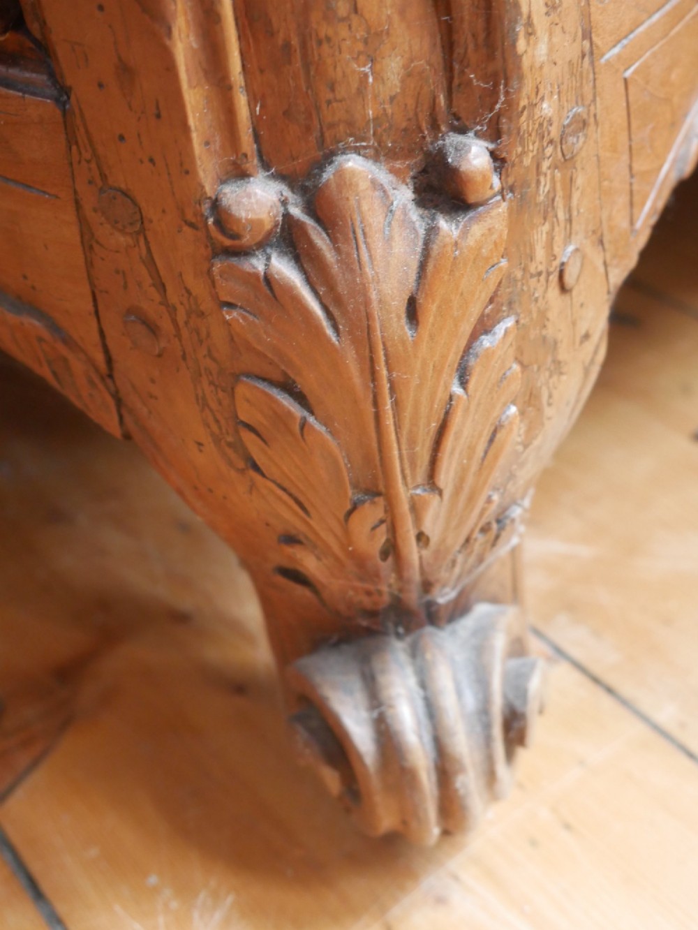 An eighteenth-century French provincial walnut commode featuring three drawers with brass handles, a carved apron, and short cabriole legs. View IV