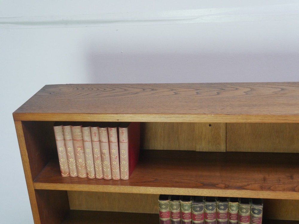 A wide, low Arts and Crafts oak bookcase featuring double open bays with multiple horizontal shelves. View IV