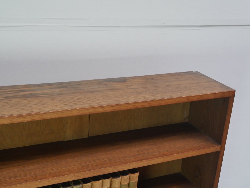 A wide, low Arts and Crafts oak bookcase featuring double open bays with multiple horizontal shelves. View VI