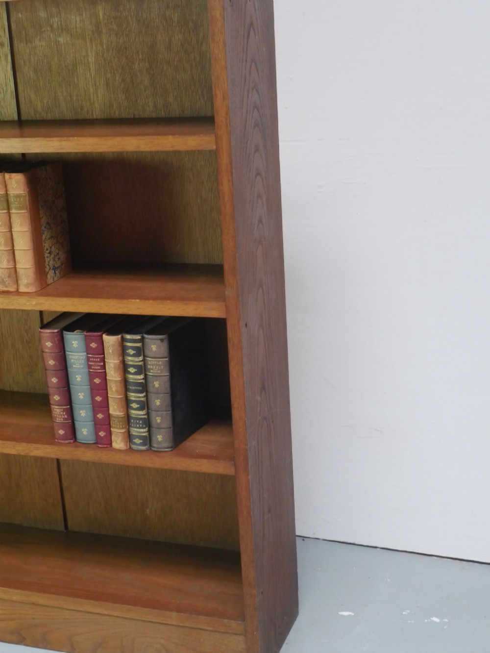 A wide, low Arts and Crafts oak bookcase featuring double open bays with multiple horizontal shelves. View VII