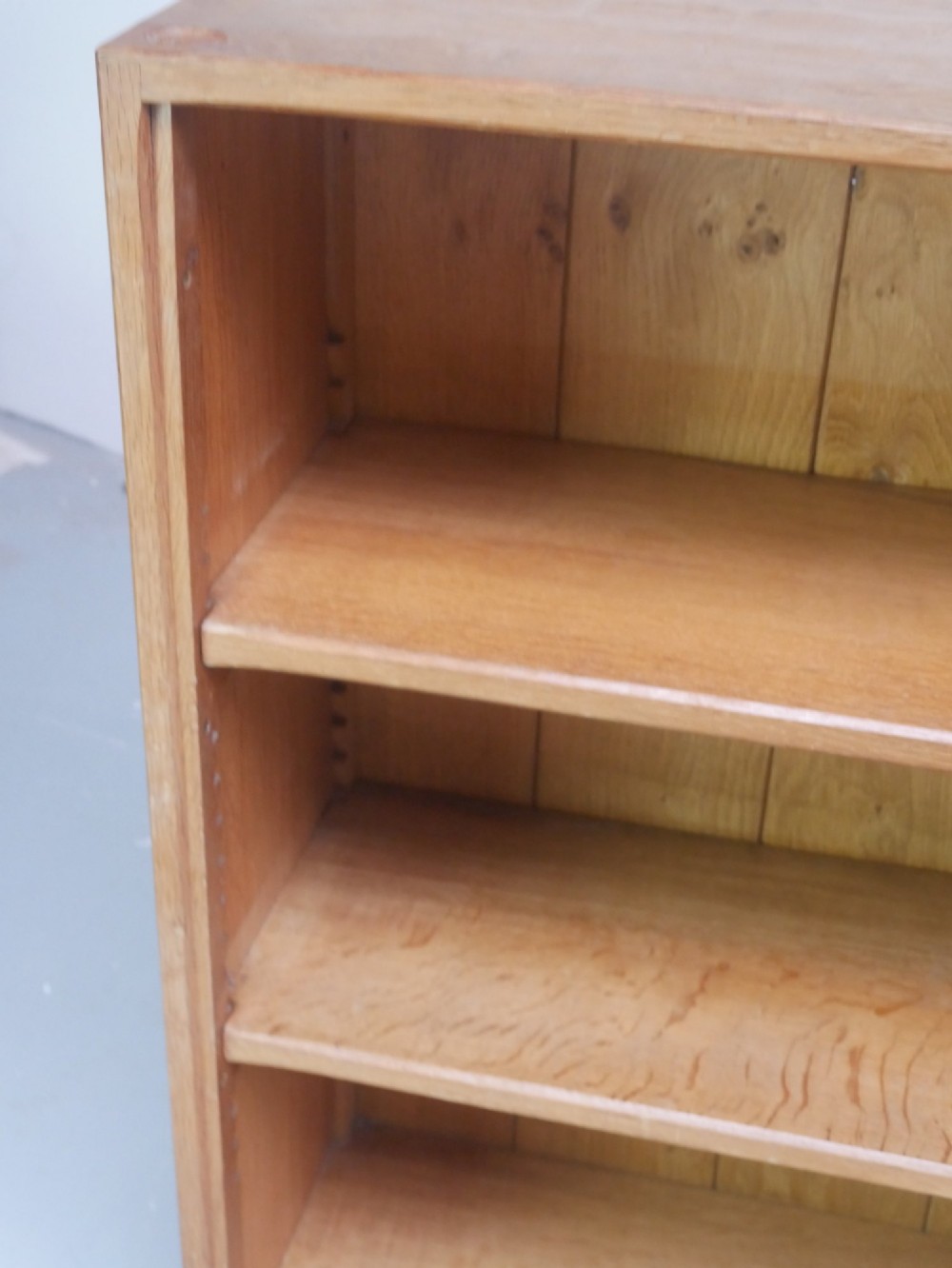 A wide, low Arts and Crafts oak bookcase featuring double open bays with multiple horizontal shelves. View X