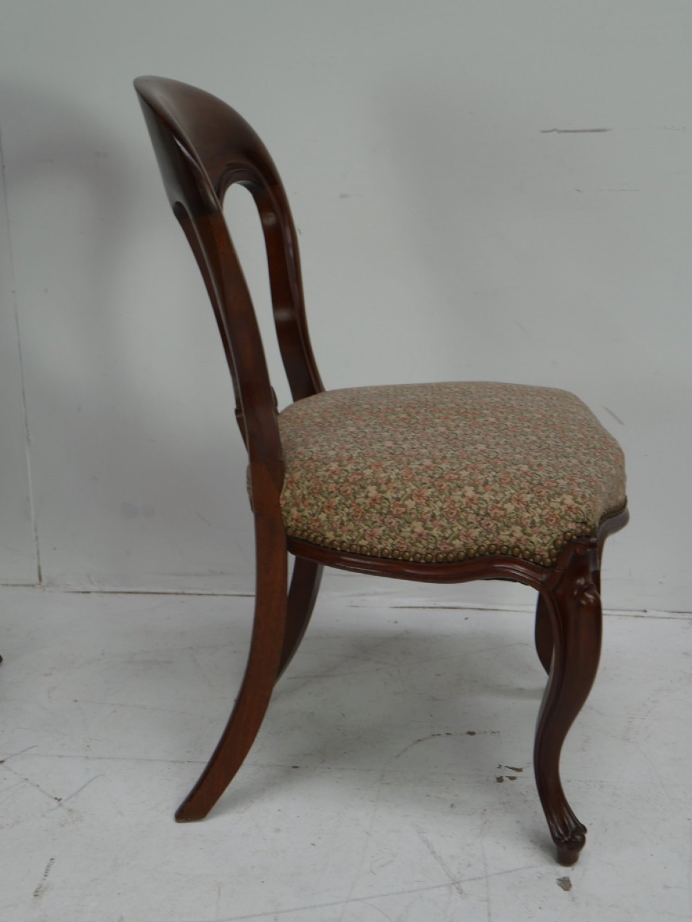 A set of four 19th-century mahogany dining chairs with carved open backs, upholstered seats, and cabriole legs. View III