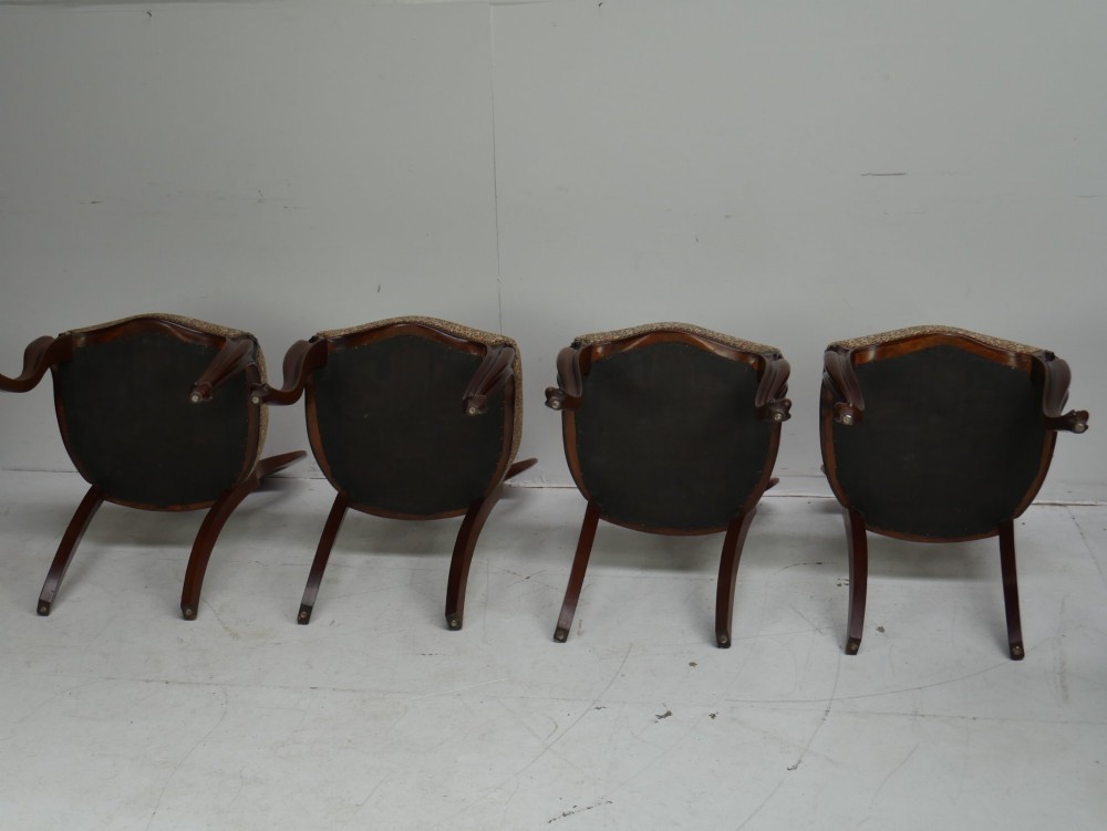 A set of four 19th-century mahogany dining chairs with carved open backs, upholstered seats, and cabriole legs. View V