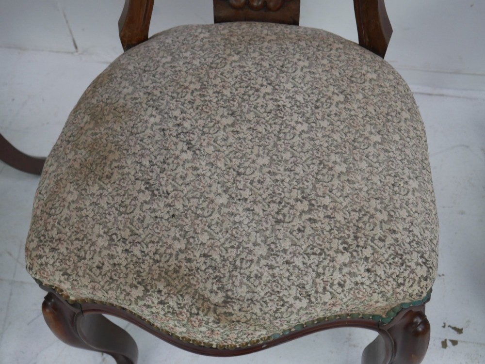 A set of four 19th-century mahogany dining chairs with carved open backs, upholstered seats, and cabriole legs. View VII