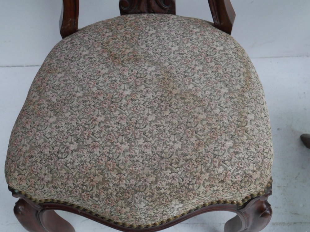 A set of four 19th-century mahogany dining chairs with carved open backs, upholstered seats, and cabriole legs. View IX