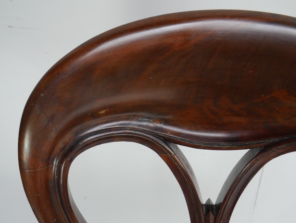 A set of four 19th-century mahogany dining chairs with carved open backs, upholstered seats, and cabriole legs. View X